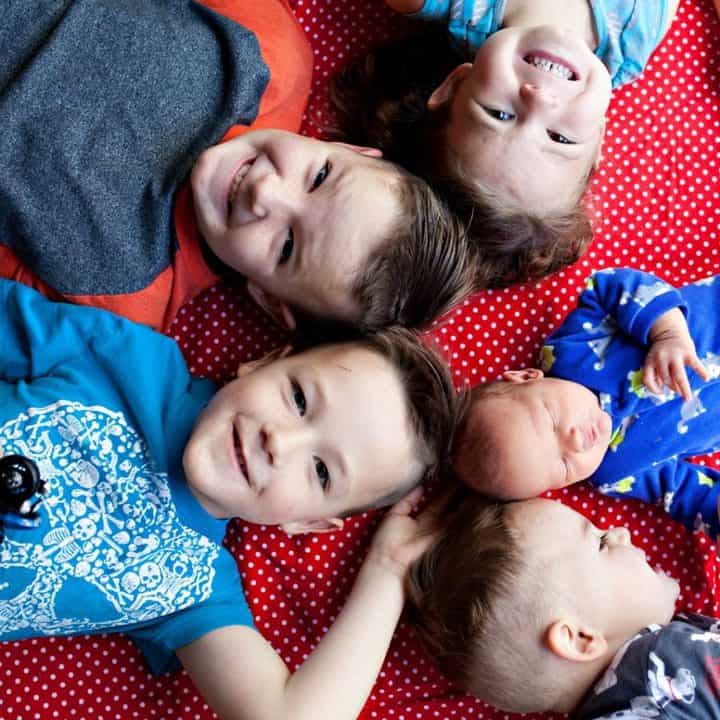 Picture of four young happy siblings and a small baby. Rules about sharing a bedroom.