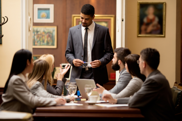 A group of lawyers during a working session and seated at a conference table. To continue a lawyer career in Canada, internationally trained professionals must meet specific requirements.