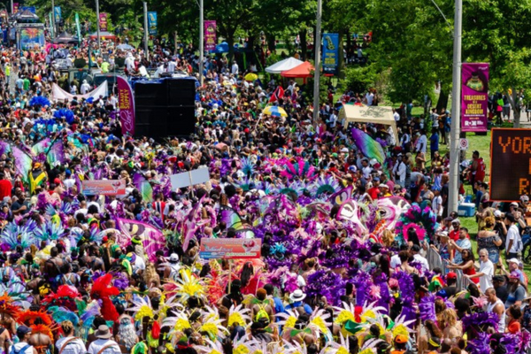 People dressed in colourful Caribbean costumes at the Toronto Caribbean Carnival summer event.