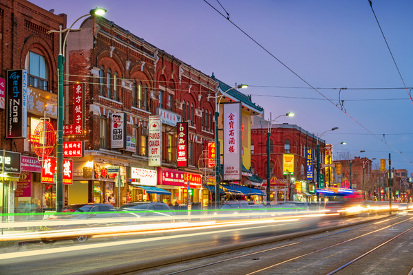 Shops and restaurants at night in Toronto's Chinatown neighbourhood.

