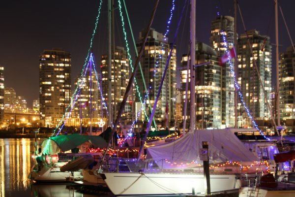 Boats moored in False Creek, Vancouver, British Columbia are decorated with lights for Christmas in Canada. 