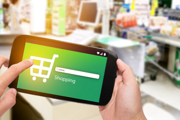A shopper is comparing shopping prices on their mobile phone to look for cost saving ideas  