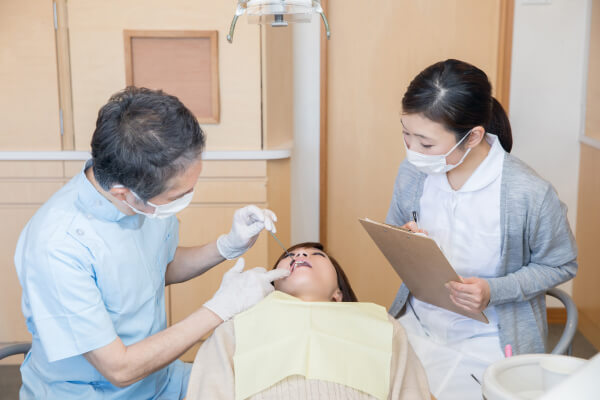 Professor assessing dental hygienist 