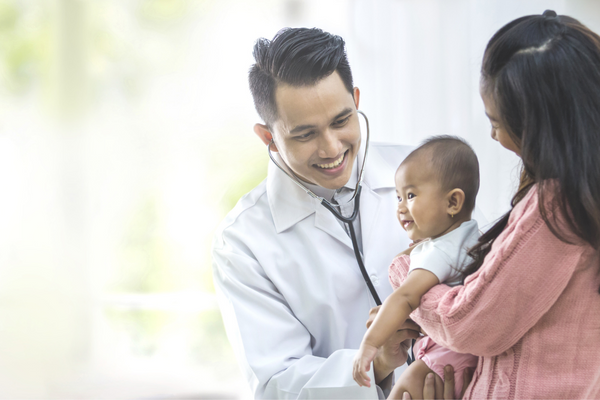 Doctor with a stethoscope checking a baby