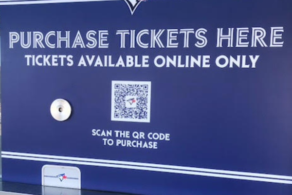 A sign on the outside of the Rogers Centre indicates where to purchase tickets for a Blue Jays game.