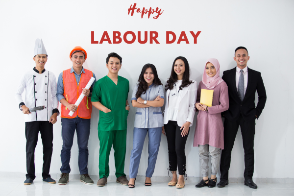 Text with Happy Labour Day with a group of diverse professionals who celebrate the Labour Day holiday in Canada.