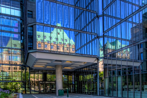 Canadian Parliament Building is reflected in the Bank of Canada building in Ottawa, Ontario.  The Bank of Canada is a major employer in Ottawa.
