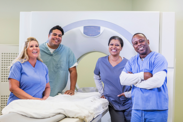 An MRT team standing in an imaging room in a hospital.