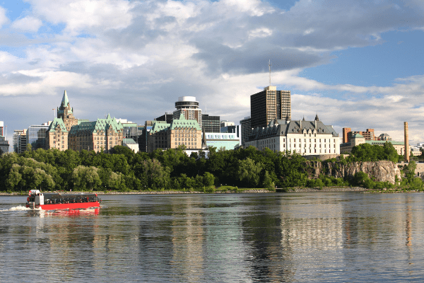 Ottawa Ontario is one of many cities that you can immigrate to through the OINP. Picture of the Ottawa skyline with the Parliament Buildings in the background.