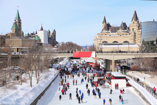 People saking on the Rideau Canaal in Ottawa and dressed for the winter season in Canada.