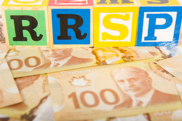 RRSP block letters are placed on top of Canadian hundred dollar bills.