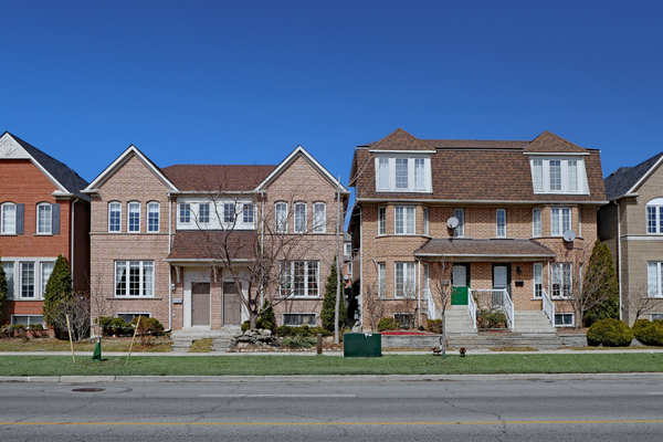 Semi-detached homes pictured on a residential street. This type of housing is usually less expensive than single-detached homes.