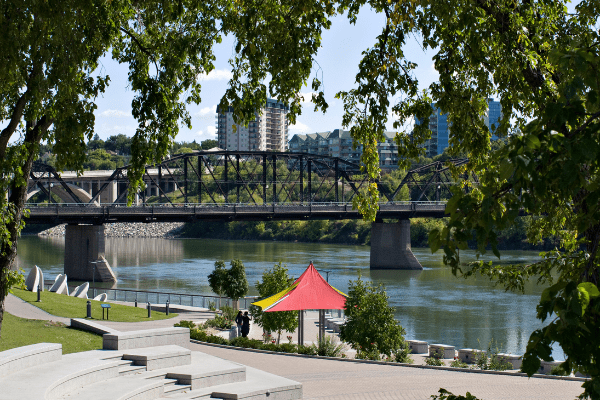 River Landing promenade with a bridge and apartments in the background.