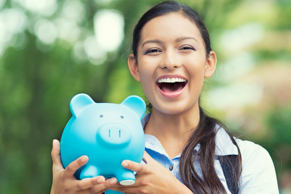 Smiling woman with a ceramic piggy bank with funds for her Canadian bank account