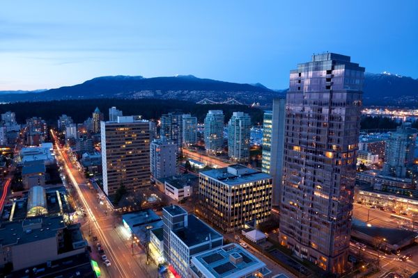 Vancouver, British Columbia is a Canadian city located on the west coast. Skyline of Vancouver with the Lion's Gate Bridge and mountains in the background.