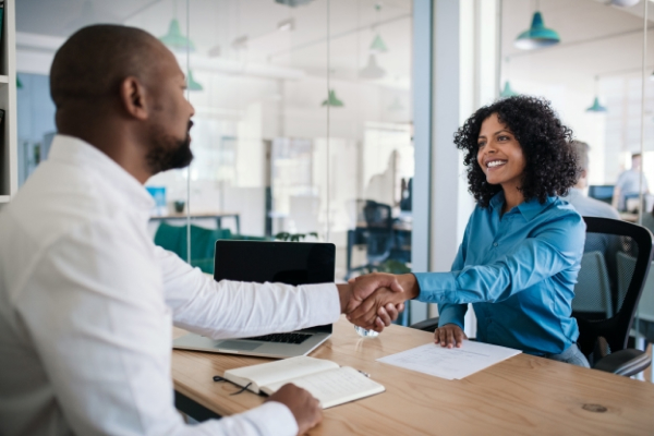 A recruiter is wrapping up an interview with a prospective job applicant. Conducting interviews is one of many responsibilities of an HR professional. 