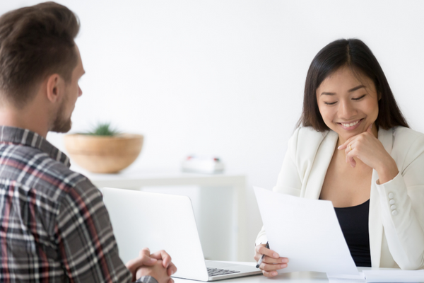 Woman reviewing a Canadian-style resume with an interview candidate.